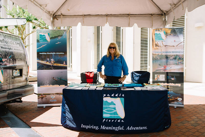 A partner exhibit table with banners at a past Sports Day