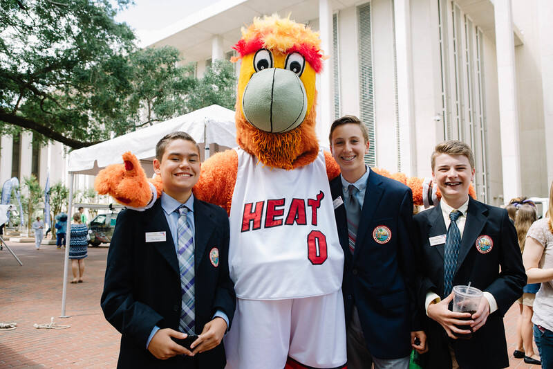 The Miami HEAT mascot with students in blazers